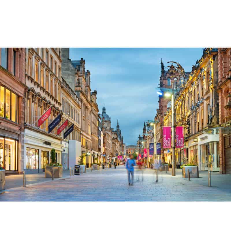 George Square walkway at night time with people walking and shopping 