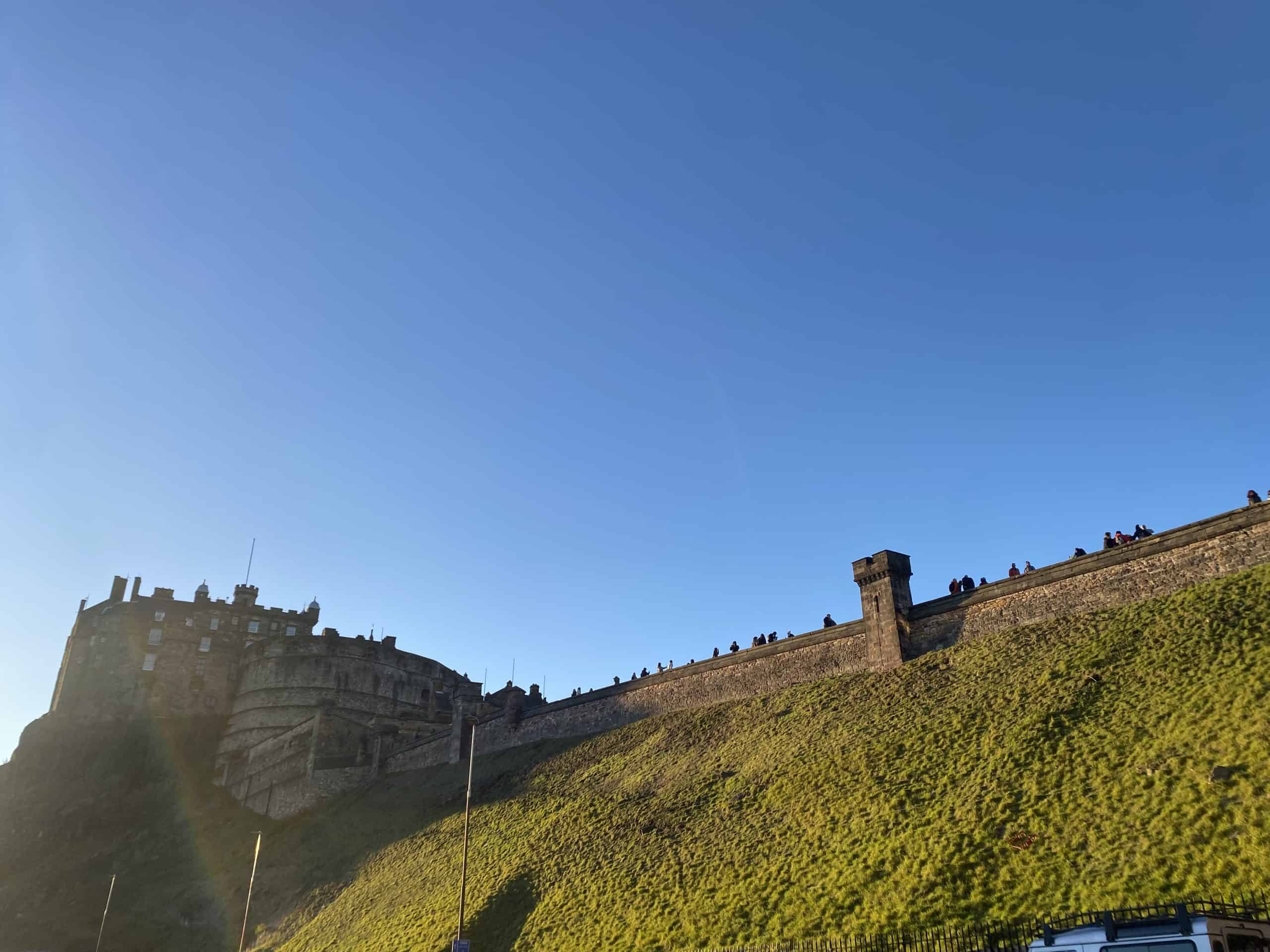 Edinburgh Castle view with people visiting and looking over walls 