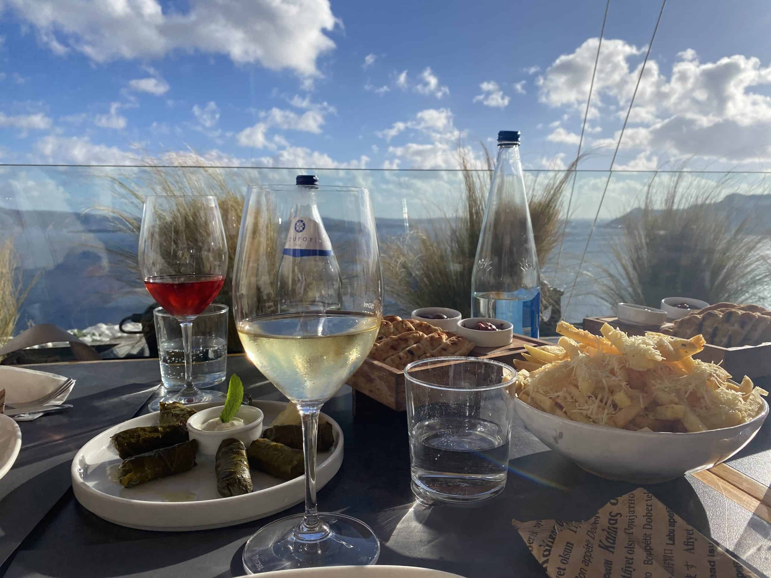 Wine and appetizers with ocean and island in the background