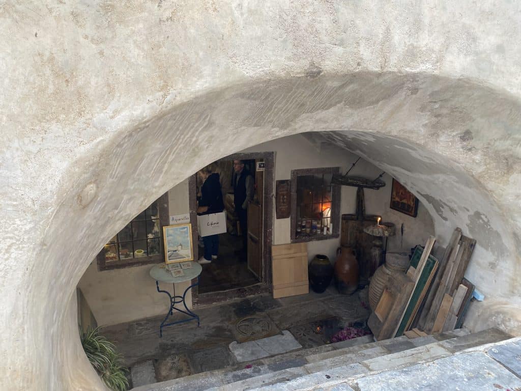Old cave building with wood frames and artwork on stairs