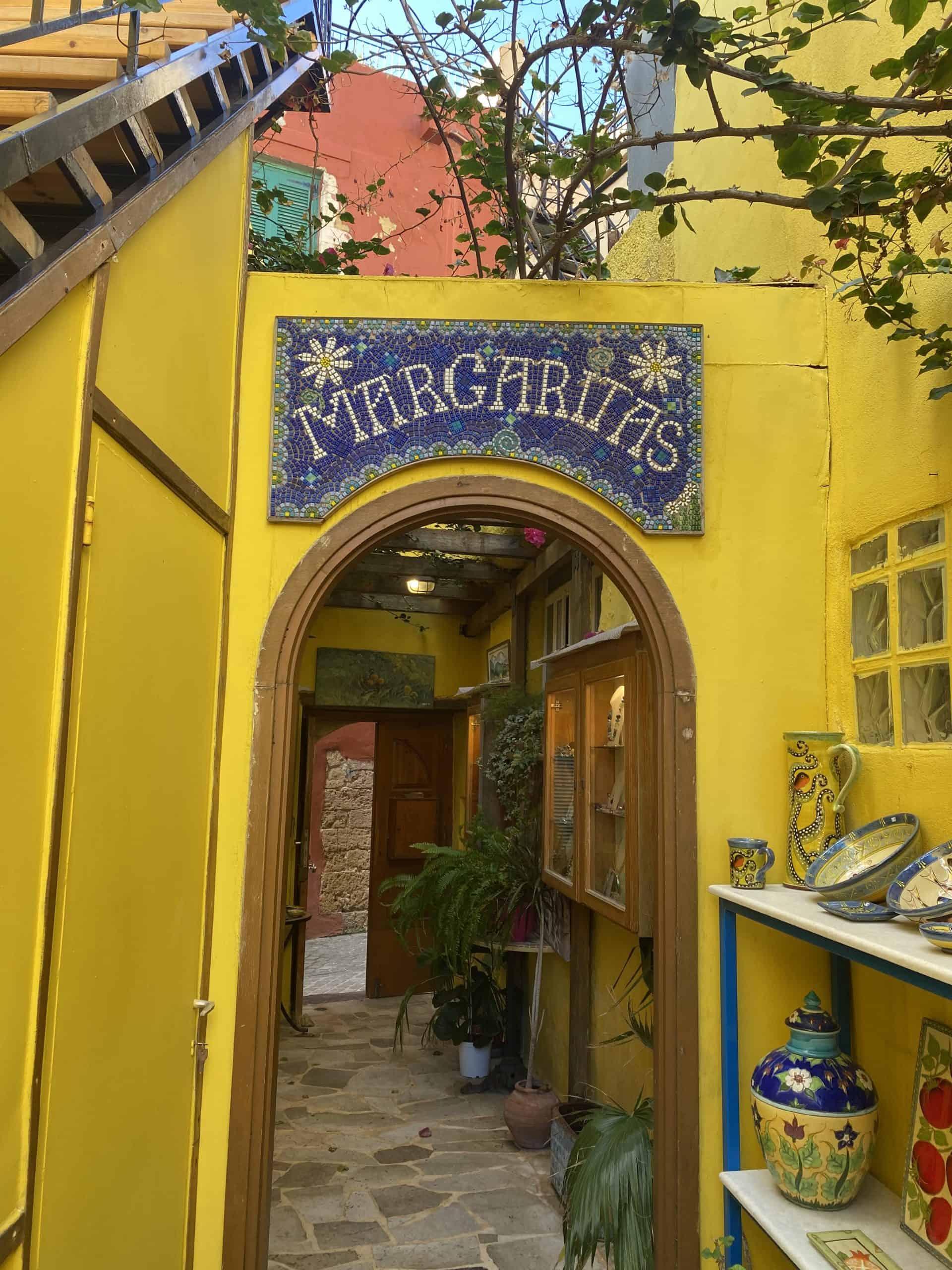 Yellow building with pottery and wood frames and windows 
