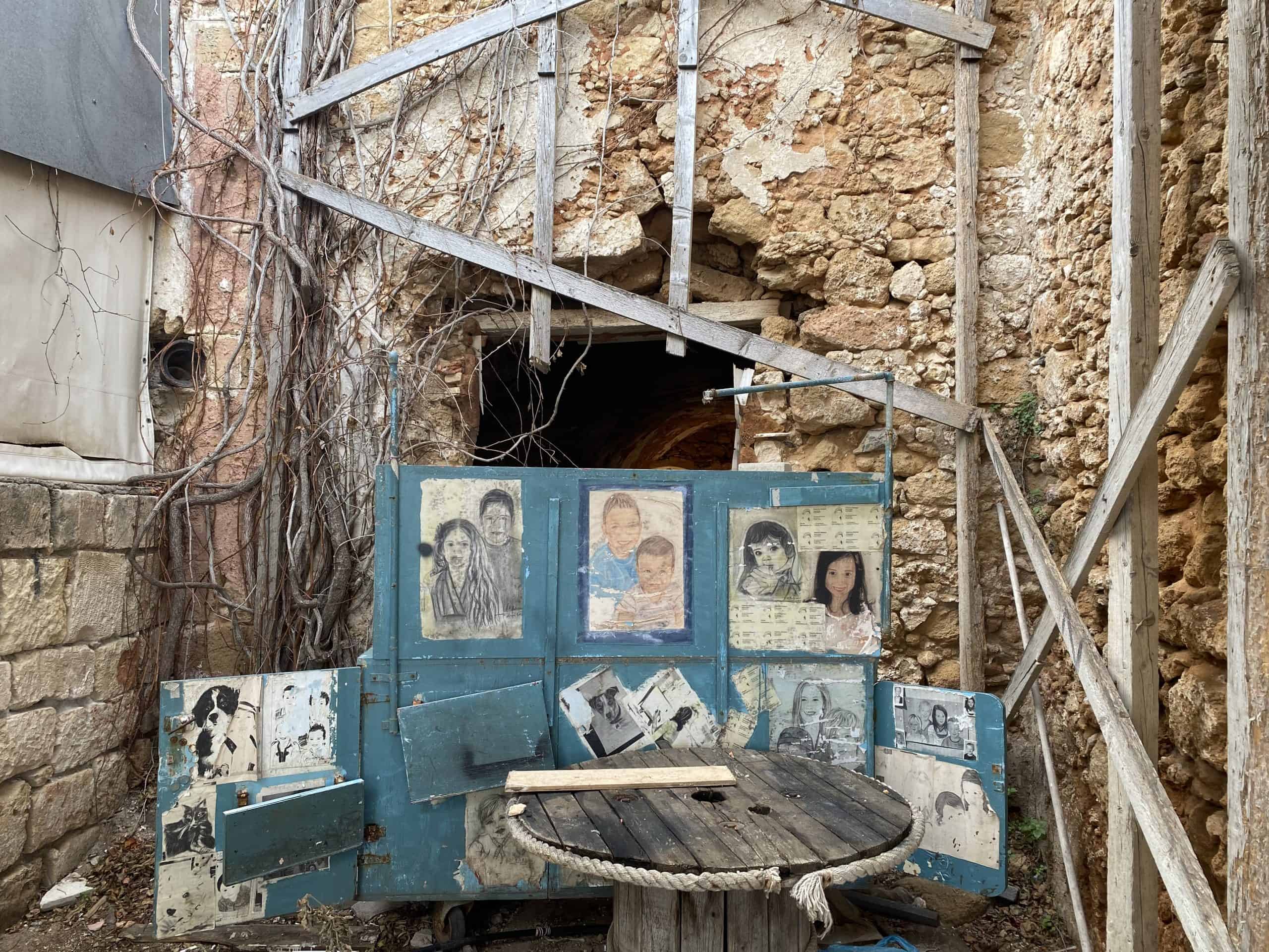 Corner of a brick building with wood and paintings 