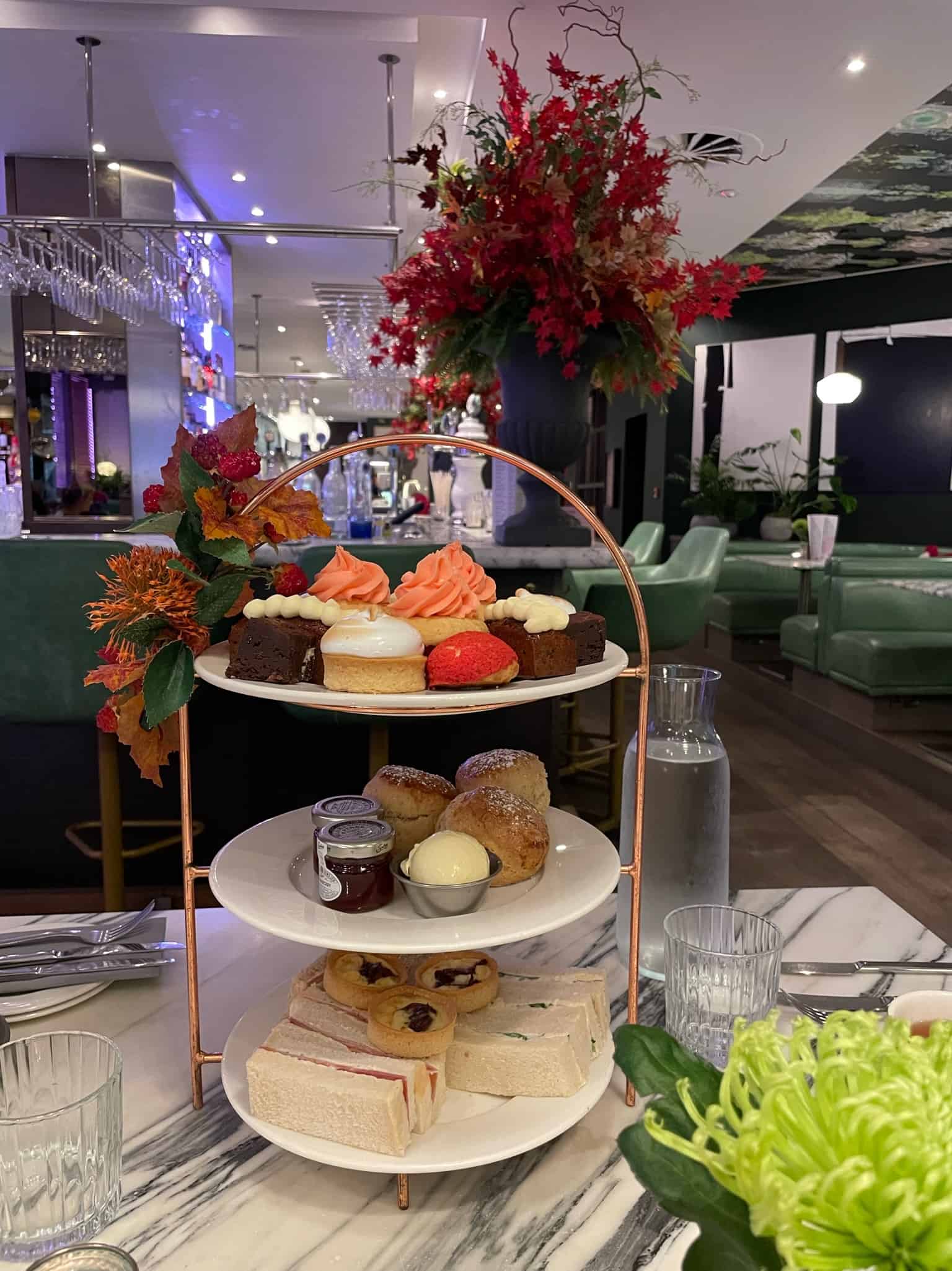 Edinburgh High Tea with pastries in bright colored dining room with flowers 