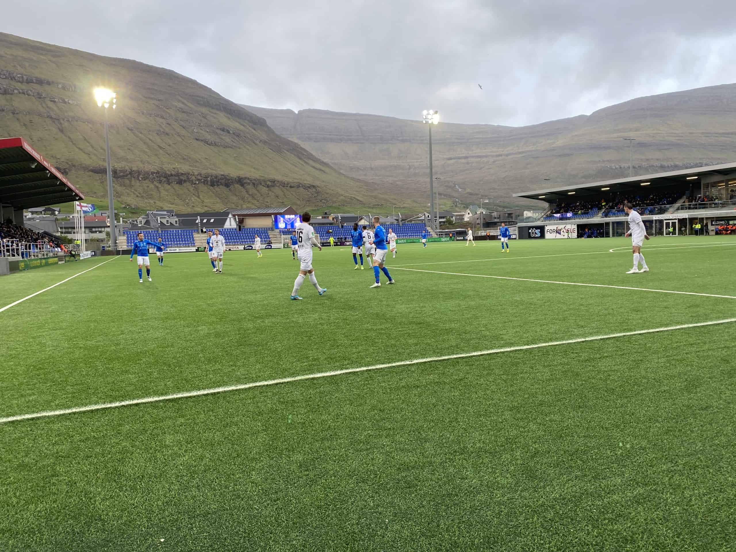Faroe Islands soccer team playin a match with mountains in the next to field 