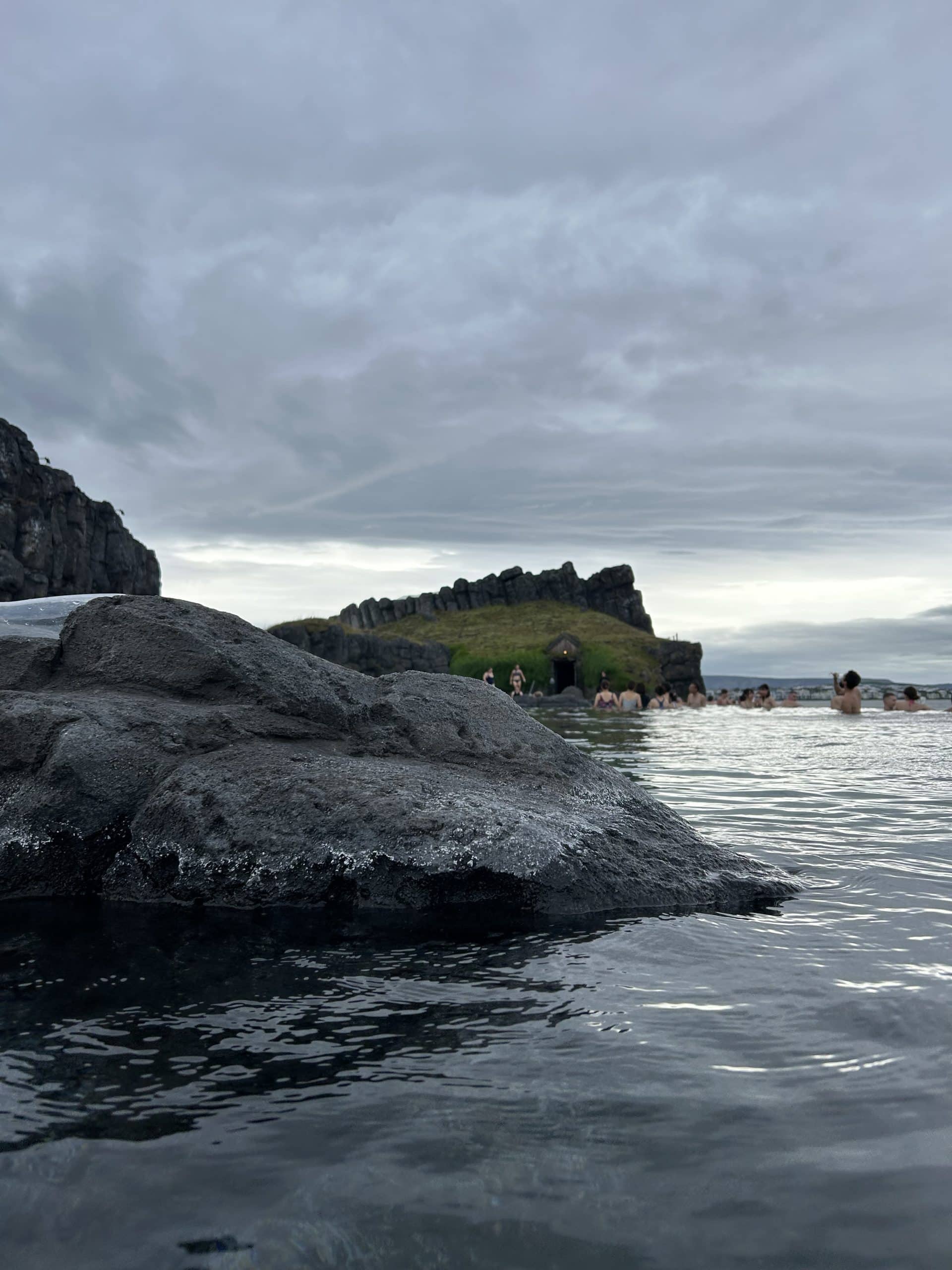 Sky Lagoon in Iceland with people in the lagoon. 